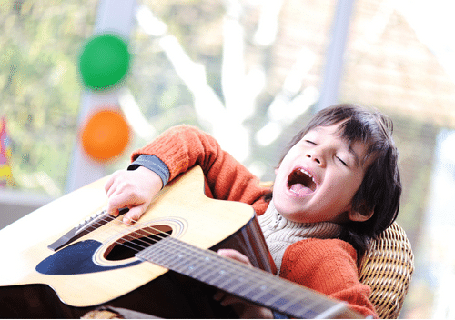 Child singing with a guitar